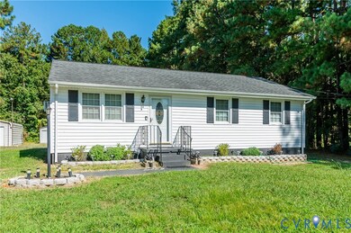 View of front of home featuring a front lawn and roof with shingles