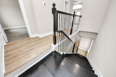 This photo shows a modern staircase with black ste