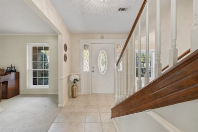 Leaded glass entry door and sidelights to traditional foyer entrance
