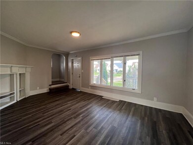 Hardwood floored living room with crown molding