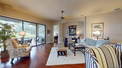 Looking from end of kitchen bar/island across living area toward master bedroom and lanai. The Brazilian Hickory hardwood floors continue from living area into master suite.