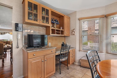Office space featuring built in study area and light tile patterned floors