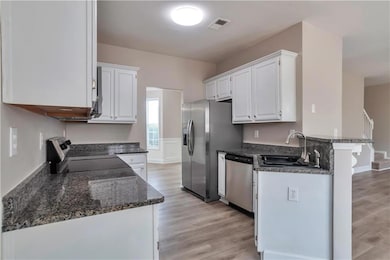 Kitchen featuring a sink, stainless steel applianc