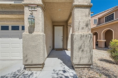 Doorway to property with a garage and stucco sidin