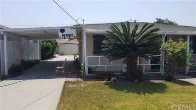 Front yard, carport, driveway and storage shed in 