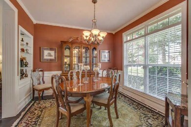 Formal dining room looks out to front yard and into great room 