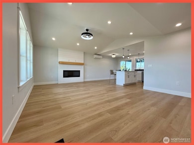 Bright and airy great room with vaulted ceilings and fireplace with wood mantle for those PNW chilly evenings.