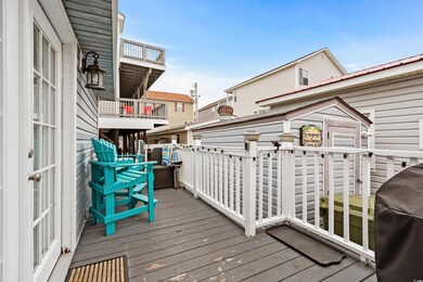 Wooden deck featuring area for grilling