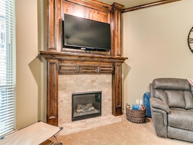 Living room featuring a brick fireplace and carpet flooring