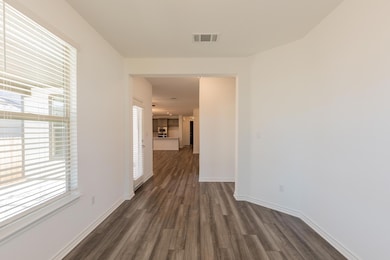 Corridor featuring visible vents, dark wood-style