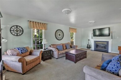 Large and cozy! This family room extends from the front to the back of the house giving you natural light from all four sides.