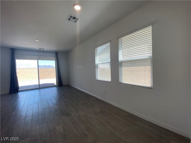 Empty room with dark wood-style flooring and recessed lighting