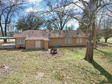 Rear view of house with a lawn