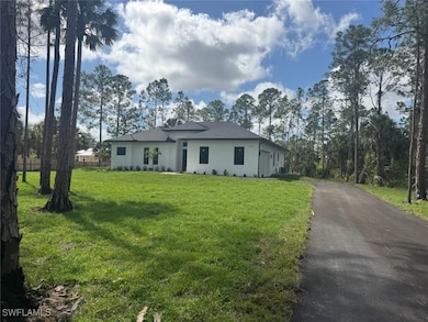 View of front of property featuring driveway and a