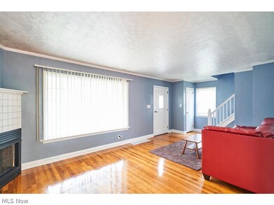 Living room featuring hardwood / wood-style flooring and a tile fireplace