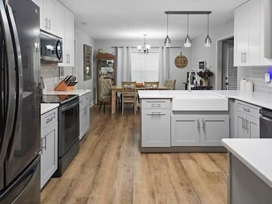 Kitchen featuring sink, hanging light fixtures, ki
