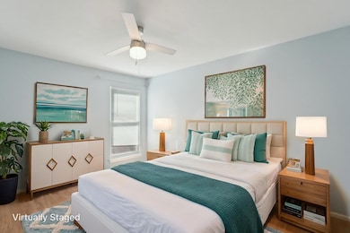 Bedroom featuring ceiling fan and wood finished f