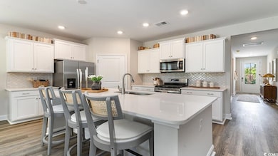 Kitchen with white cabinets, a center island with 