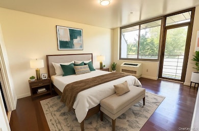 Bedroom with access to outside, dark wood-type flooring, and a wall mounted air conditioner