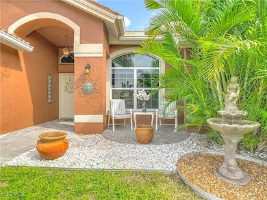 Entrance to property with a patio area and fountain.