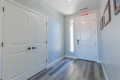 Foyer entrance featuring baseboards and light wood-style flooring
