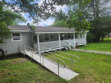 Ranch-style home with a porch and a front lawn