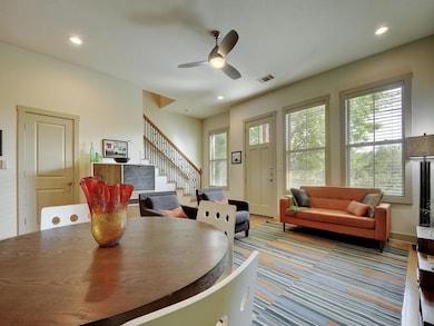 Dining space with stairs, a ceiling fan, recessed
