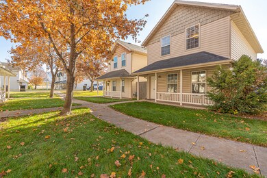 Traditional-style home with covered porch and a front lawn