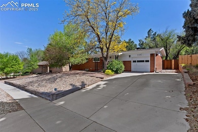 Single-level home featuring brick exterior, garage, and concrete driveway