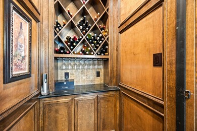 An elegant built-in wine cellar elevates the forma