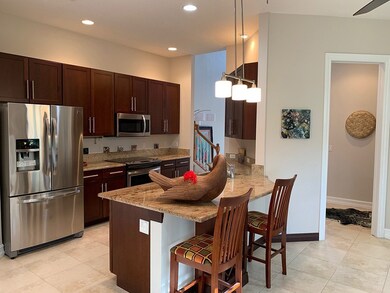 Large island kitchen overlooks dining room.