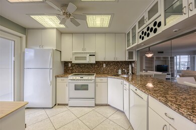 Kitchen is open and spacious and features white ca