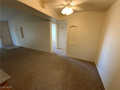 Carpeted empty room with ceiling fan