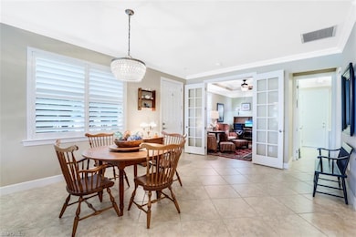 Dining area with elegant lighting, front door and 