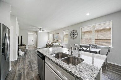 The view from behind the island. Great floor plan! The refrigerator is less than a year old and it conveys with the home!