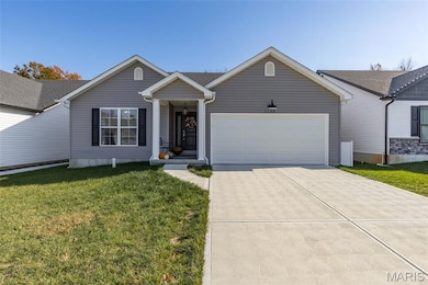 Single story home with driveway, a front yard, and an attached garage