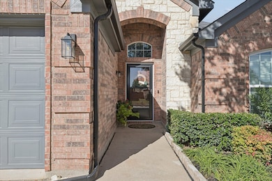 Doorway to property featuring brick siding and stone siding