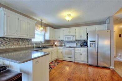 Freshly Painted Cabinetry & New Tile Backsplash an