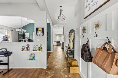 Foyer has convenient bag drop area to the right and formal living (currently used as a home office) to the left.