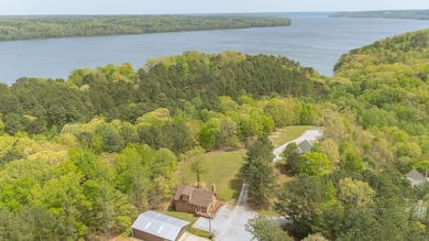 Aerial view with a wooded view and a water view