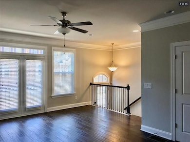 Spare room featuring a ceiling fan, dark wood-style floors, ornamental molding, and recessed lighting