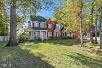 Traditional-style house featuring covered porch and roof with shingles