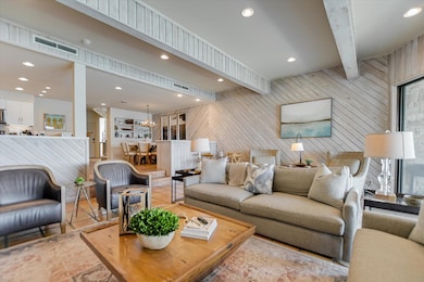 Living area featuring wood walls, light tile patt