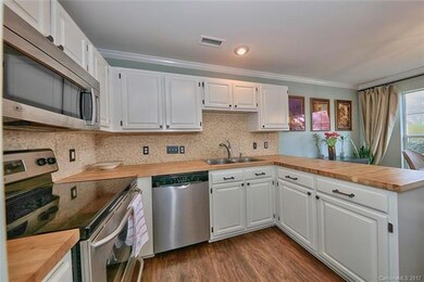Kitchen with butcher block counter tops.