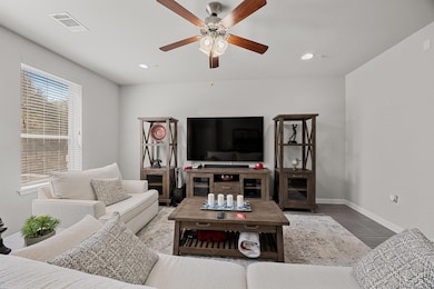 Living room with visible vents, recessed lighting