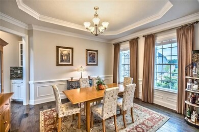 Wainscoting lines the elegant dining room with adj