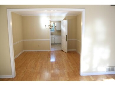 View from Living room into Diining room and into k
