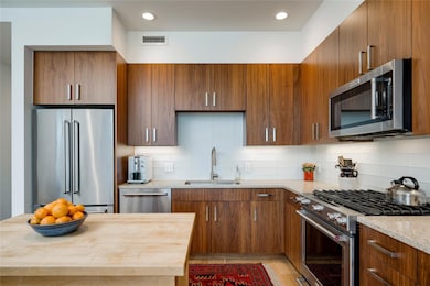 Kitchen featuring appliances with stainless steel