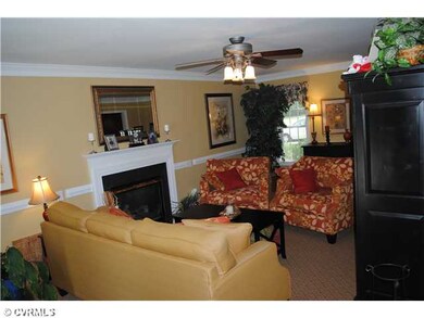 Living Room - Gas fireplace. Ceiling fan, chair rail, and double crown moulding, french doors leading out to the deck.