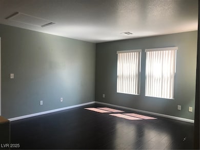 Spare room featuring baseboards and dark wood-styl